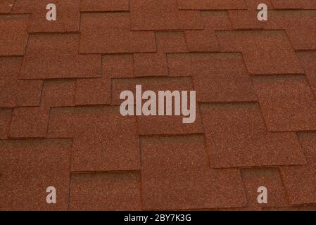 red roof. Metal tile. Part of the house roof as a backdrop for designers. Stock Photo