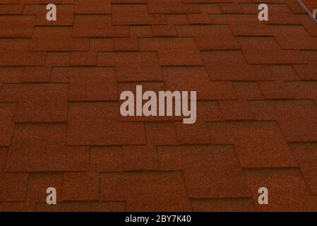 red roof. Metal tile. Part of the house roof as a backdrop for designers. Stock Photo