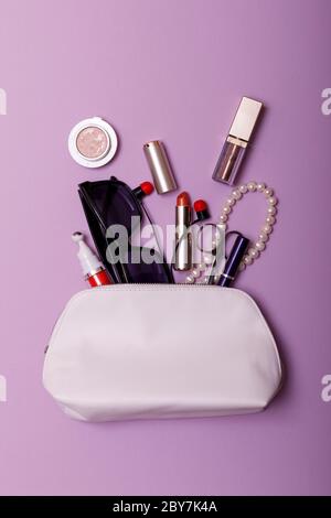 Make up bag with cosmetics isolated on pink background Stock Photo