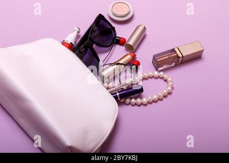 Make up bag with cosmetics isolated on pink background Stock Photo