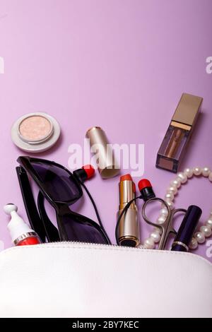 Make up bag with cosmetics isolated on pink background Stock Photo