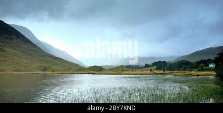 In drizzle and overcast skies and to the sound of rutting stags in the hills, view across Loch Beannacharain from the road to Scardroy. 25/09/19 Stock Photo