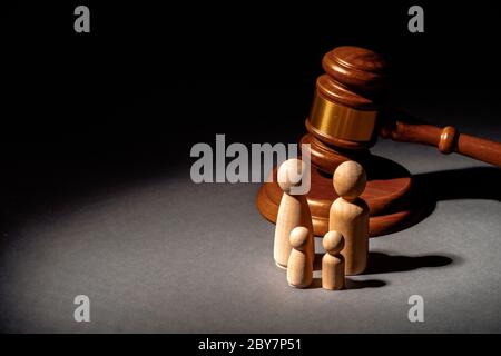 Wooden toy family and judge mallet. Family divorce concept Stock Photo