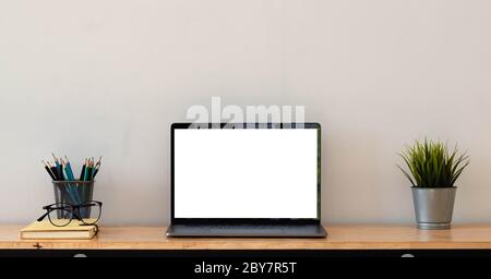 Cropped shot of simple workspace with blank screen laptop, cup, stationery and copy space Stock Photo