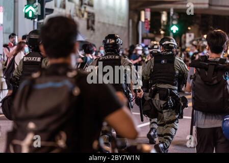 Hong Kong SAR, China. 9th June 2020. Hong Kong riot police storm into the crowd  as hundreds of Hongkongers defy a police ban and take over the streets in the Central business district to mark the one year anniversary of the Hong Kong pro-democracy protests. Credit: Ben Marans/Alamy Live News. Stock Photo