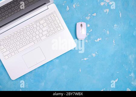 Computer laptop on blue desk. Online work or education concept top view. Laptop on table for freelance, work, training, educations blogging, office co Stock Photo