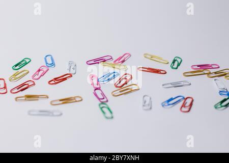multicolored paper clips on white background Stock Photo
