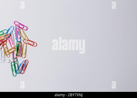 multicolored paper clips on white background Stock Photo