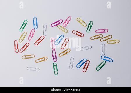 multicolored paper clips on white background Stock Photo