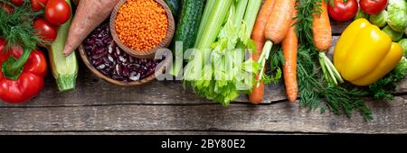 Background healthy eating. Fresh vegetables, fruits, beans and lentils on wooden table. Vegetarian food. Healthy food, diet and healthy eating concept Stock Photo