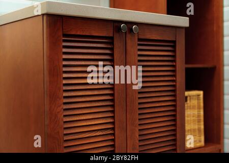 Modern bathroom interior details with wooden furniture and mint tile walls Stock Photo