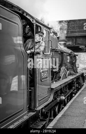 The driver of BR 'Hall' 4-6-0 No. 6990 'Witherslack Hall' waits to depart from Loughborough station on the Great Central Railway Stock Photo