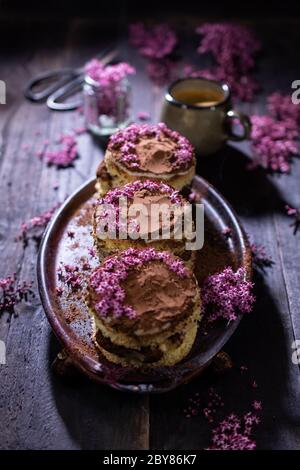 Chocolate muffins with flowers.Dessert with coffee.Healthy food and drink.Mini cupcake. Stock Photo