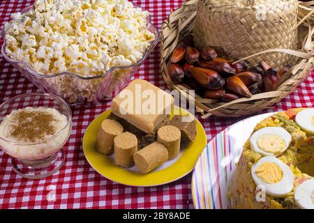 Typical Brazilian junina party food and sweets. Couscouz, peanut candy, sweet rice, dulces de leche and and pine nuts. Stock Photo