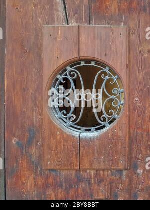 Circle lattice window on wooden door Stock Photo