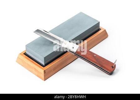 Jackknife and a whetstone isolated on white background Stock Photo