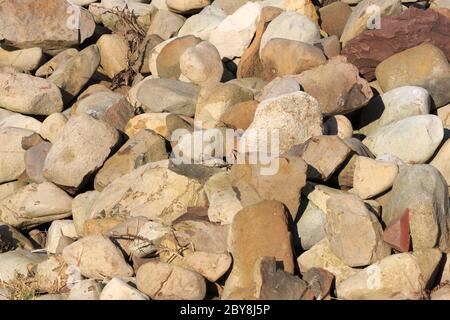 close up on a pile of sunlit boulders Stock Photo