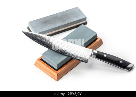 Japanese chef's knife and whetstones isolated on white background Stock Photo