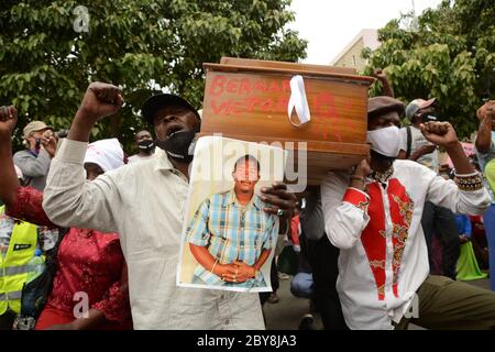 Nairobi, Kenya. 09th June, 2020. Residents of Mathare slums are seen carrying an empty coffin and a photo of one of their own who was killed by police during the demonstrations.Residents of Mathare slums demonstrate outside the parliament building in a protest against police killings and brutality in the area while wearing facemasks with names of those who had been killed by police. Credit: SOPA Images Limited/Alamy Live News Stock Photo