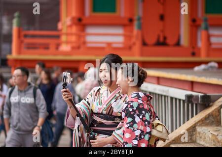 Kyoto / Japan - November 3, 2017: Pretty Japanese girls dressed in traditional kimonos, taking selfies at Kiyomizu-dera temple in Kyoto, Japan Stock Photo