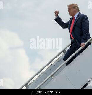 U.S. President Donald Trump holds up his fist as he deplanes from Air Force One to witness the launch of a SpaceX Falcon 9 rocket carrying the Crew Dragon spacecraft at the Kennedy Space Center May 30, 2020 Cape Canaveral, in Florida.