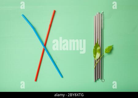 single use plastic and reusable metal eco-friendly drinking straw. zero waste concept Stock Photo