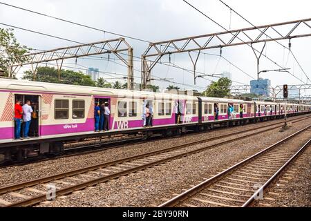 Unidentified Passengers Standing on the Doors of Running Local Train during  Rush Hours Editorial Photography - Image of station, india: 168031082