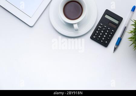 office desk with digital tablet, tea and calculator on white background  Stock Photo