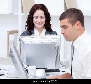 Self-assured young business people working at computers Stock Photo