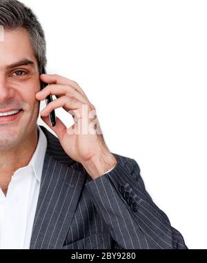 Close-up of a smiling businessman on phone against a white background Stock Photo