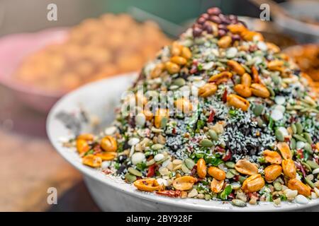 Closeup shot of delicious dessert meal of muesli with  oats, grains, nuts and seeds in a white bowl Stock Photo