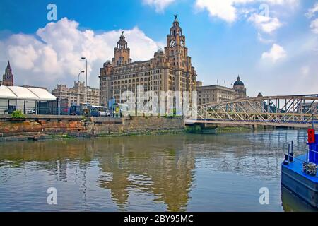 Liverpool waterfront with the The Royal Liver Building in the foreground & reflections of the city in the Mersey river, Liverpool, England, UK. Stock Photo