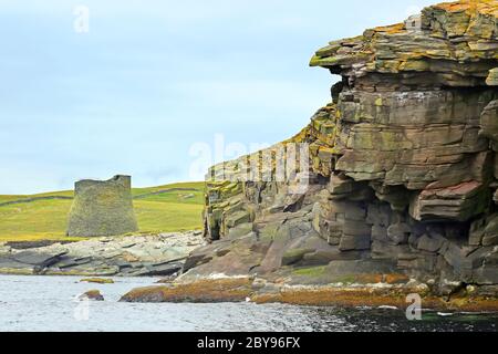 Broch of Mousa;  which is a preserved Iron Age round tower on the rocky coastline. It is on the island of Mousa in Shetland, Scotland. Stock Photo