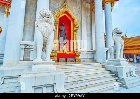 BANGKOK, THAILAND - MAY 13, 2019: The carved stone singha lions guard the Ubosot hall of Wat Benchamabophit Dusitvanaram Marble Temple, on May 13 in B Stock Photo