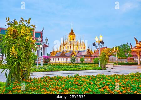 The colorful flowers in evening Mahajetsadabadin park, located in front of Wat Ratchanatdaram Buddhist complex, Bangkok, Thailand Stock Photo