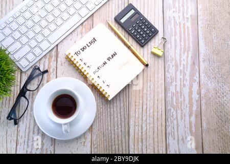 Coffee cup and notebook with to do list on on wooden table  Stock Photo