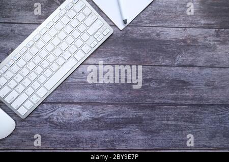 high angle view of keyboard, notepad and computer mouse on table  Stock Photo