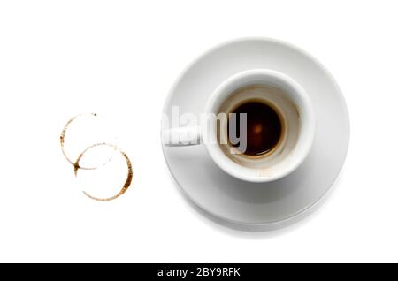 Dirty empty white coffee cup on saucer, two brown circle coffee stains on white background. Top view. Closeup Stock Photo