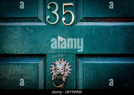 House number 35 with exotic door knocker Stock Photo