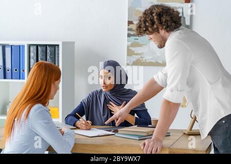 Hot discussion in the office. Coworkers talking about a project and arguing Stock Photo