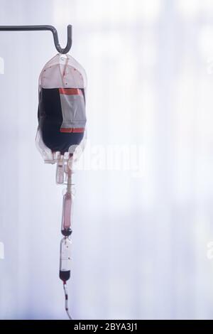 Spare blood bags from laboratory medical hanging on a steel pole at the hospital In order to prepare blood for the veins of the patients who want to d Stock Photo