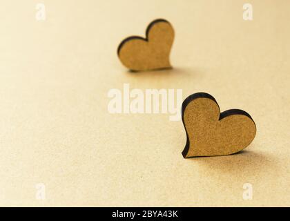 two wooden hearts on craft background Stock Photo