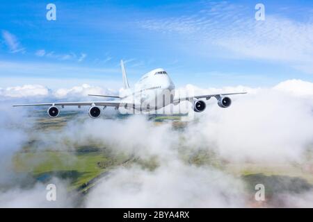 The plane gains altitude flying through a dense layer of clouds, travel flight Stock Photo
