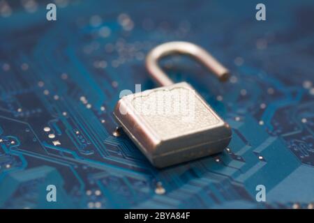 Opened security lock, open padlock on background blue computer printed circuit board. Cyber Security, virus protection concept. Computer security brea Stock Photo