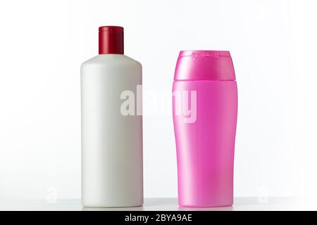 Two nameless plastic bottles white and pink from under a cosmetic product on a white background Stock Photo