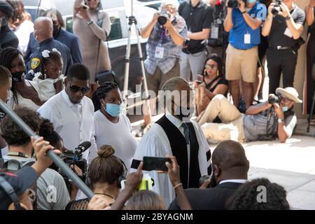 Family members along with Reverend AL Sharpton prepare to enter the sanctuary of Fountain of Praise Church in Houston on June 9, 2020 for the funeral service honoring the life of GEORGE FLOYD. Floyd 's death 2 weeks ago at the hands of a white policeman, set off hundreds of protests worldwide against police brutality and racism. Stock Photo