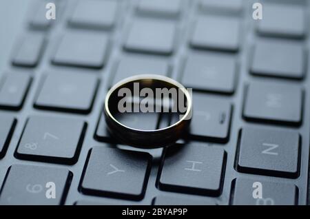 STARGATE: A gold ring appears on the keyboard of a laptop computer. Stock Photo