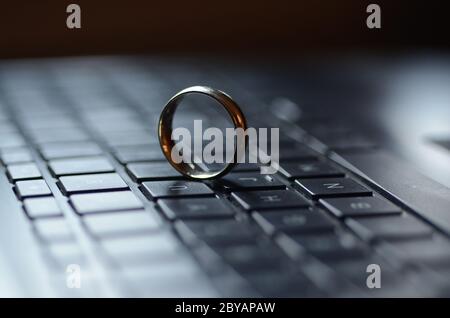 STARGATE: A gold ring appears on the keyboard of a laptop computer. Stock Photo