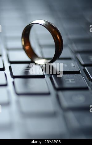 STARGATE: A gold ring appears on the keyboard of a laptop computer. Stock Photo