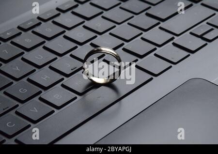 STARGATE: A gold ring appears on the keyboard of a laptop computer. Stock Photo